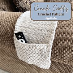 a crocheted couch with a camera in the pocket and text overlay that reads, coach caddy crochet pattern