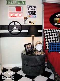 a bedroom with black and white checkered flooring, red walls and bedding