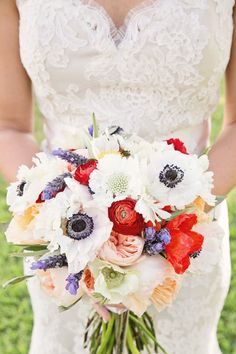 a bride holding a bouquet of flowers in her hands