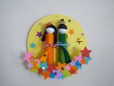 two colorful toothbrushes are placed on a yellow circle with stars around them and the words happy birthday written below it