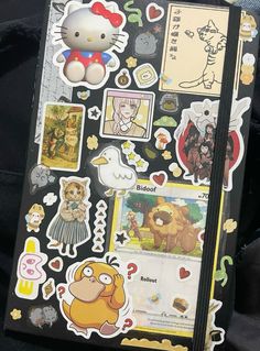 a hello kitty notebook with many stickers on it