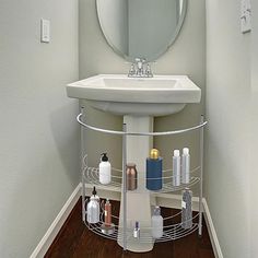 a bathroom with a sink, mirror and shelf for personal care products in it's corner