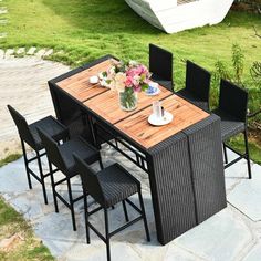 an outdoor table and chairs with flowers on it