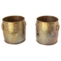 two metal buckets sitting next to each other