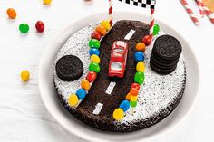 a birthday cake decorated to look like a race car with cookies and candy on the side