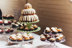 cupcakes and pastries are on display on a table