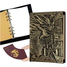 a hand holding an open book with a dragon on the cover and a passport case next to it