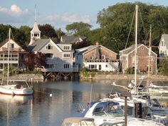 several boats are docked in the water near houses