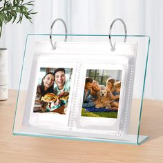 two pictures are hanging on a glass frame