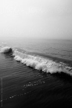 a black and white photo of the ocean waves