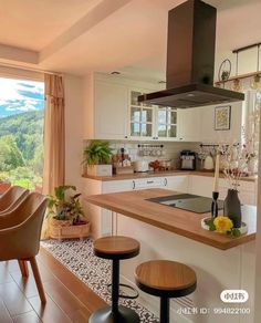 an open kitchen and dining room area with mountains in the background