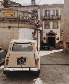 an old car parked in front of a building