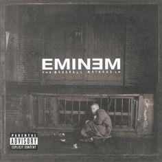 emiem album cover with a man sitting on the ground in front of a building