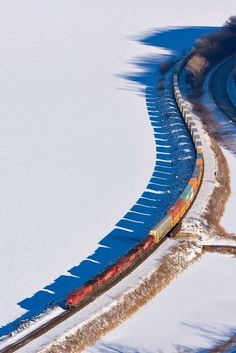 a train traveling through snow covered ground with a bible verse written on the side of it