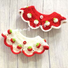 two crocheted red and white baby shoes on a wooden surface with the words sewing written below them