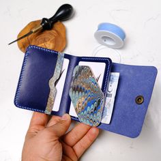 We created a colorful leather wallet by combining handcraft and quality products. ★  Each wallet made with the art of marbling is unique.  ★  Traditional marbling art patterns and colors come together only when they are made.  For this reason, all of them are special and unique to that moment. ✖ FUNCTIONAL DESIGN This wallet has 4 card slots ( Compartments receive 2 cards ) The choice of those who love minimal wallets with their multiple foldable structures. The cash compartment can hold 10 banknotes When producing this wallet, I use the best quality crazy leather, linen thread, and brass rivets. Our wallets are delivered with a gift box. You can customize your wallet for you free of charge , you can add your first and last name to the notes. ! ✖  Dimensions: 10 x 8 cm ( 3.9 x 3.1 inch ) T Blue Trifold Wallet With Card Slots For Daily Use, Blue Leather Trifold Wallet With Card Slots, Handmade Blue Leather Wallet, Artisan Wallets With Coin Pocket, Blue Wallet With Card Slots As Gift, Artisan Rectangular Card Holder As Gift, Artisan Rectangular Card Holder Gift, Handmade Leather Card Holder For Gift, Handmade Blue Wallet For Everyday Use