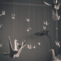 several origami birds are flying in the air