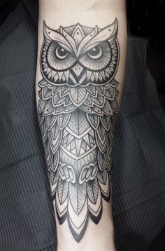 an owl tattoo on the leg