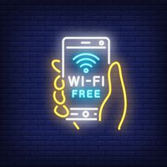 a neon sign that says wi - fi free with a hand holding a cell phone