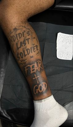 a man's leg with tattoos on it and the words did't last soldier fear to god