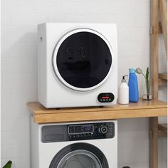 a washing machine sitting on top of a wooden shelf