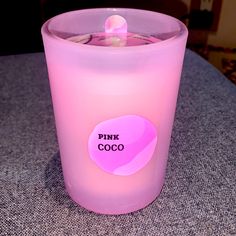 a pink candle sitting on top of a table