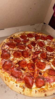 a large pepperoni pizza in a box