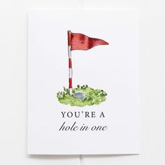 a card with an image of a red flag and the words you're a hole in one