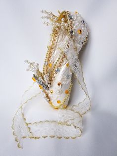 a close up of a white purse with beads and chains on it's side