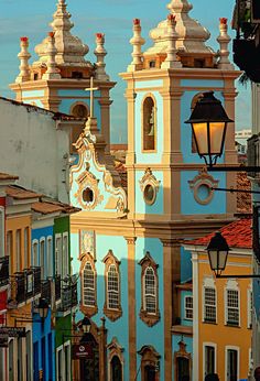 an old church in the middle of colorful buildings