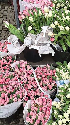 several baskets filled with pink and white tulips sitting on top of each other