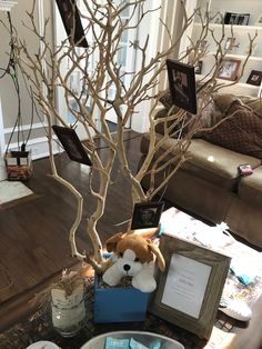 there is a stuffed animal in the centerpiece next to a tree with no leaves