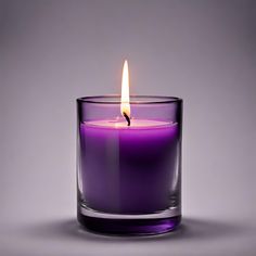 a purple candle in a glass on a gray background