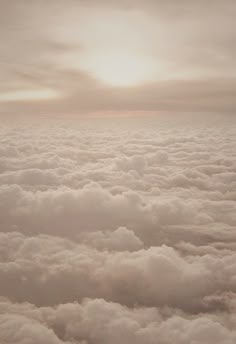 the view from an airplane looking down on some clouds