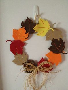 a wreath made out of paper leaves and twine