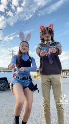 two people in bunny ears standing next to each other