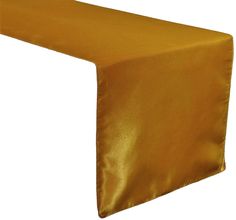 a gold satin table runner on a white background