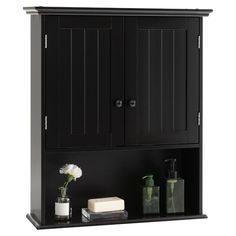 a black bathroom cabinet with two doors and soap dispenser next to it