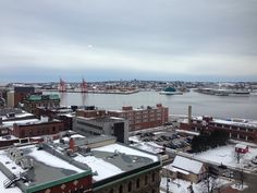 the city is covered in snow and has lots of buildings on it, including one building