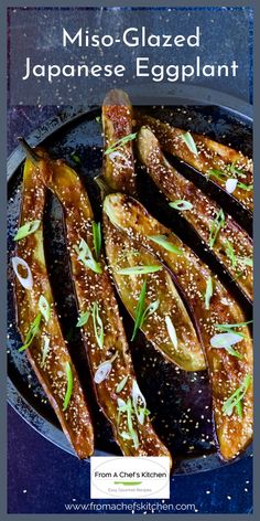 baked eggplant in a skillet with sesame seeds and seasoning on top