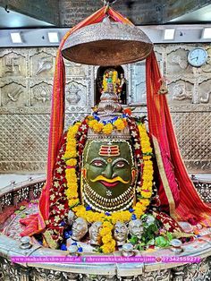 the statue is decorated with flowers and garlands