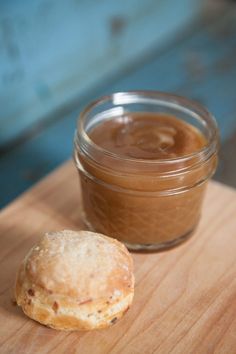 a cookie sitting next to a jar of peanut butter