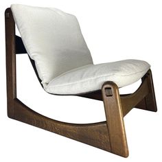 a wooden rocking chair with a white pillow on it's back and seat cushion