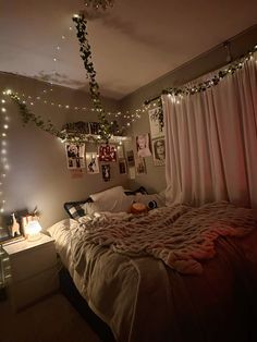 a bedroom with lights strung from the ceiling