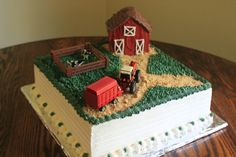 there is a cake that looks like it has farm animals on it and a barn