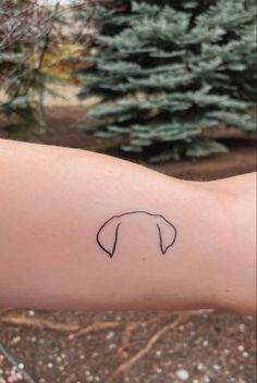 a dog's head is shown on the left arm and it appears to be in black ink