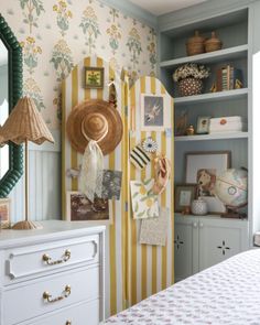 a bedroom with yellow and white striped walls