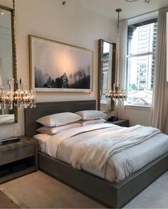 a bedroom with a large bed and chandelier