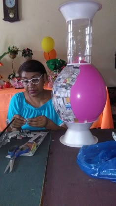 a woman sitting at a table in front of a globe