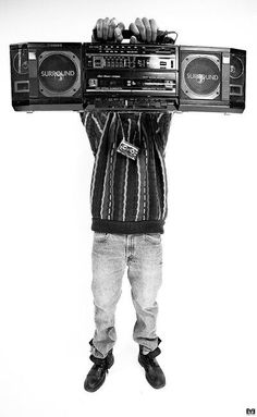 a person holding up a boombox with two hands